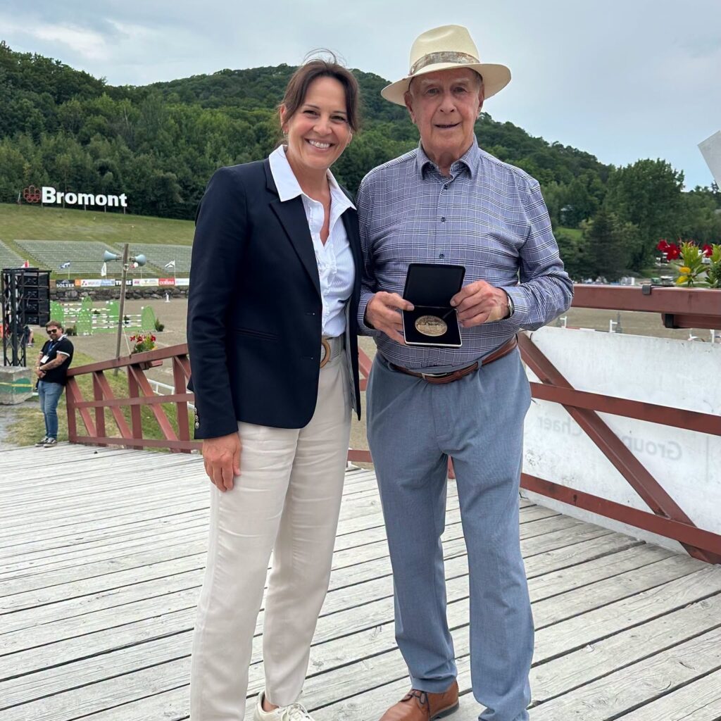 Roger Deslauriers is presented with a Member of Parliament’s Medal by Isabelle Charest